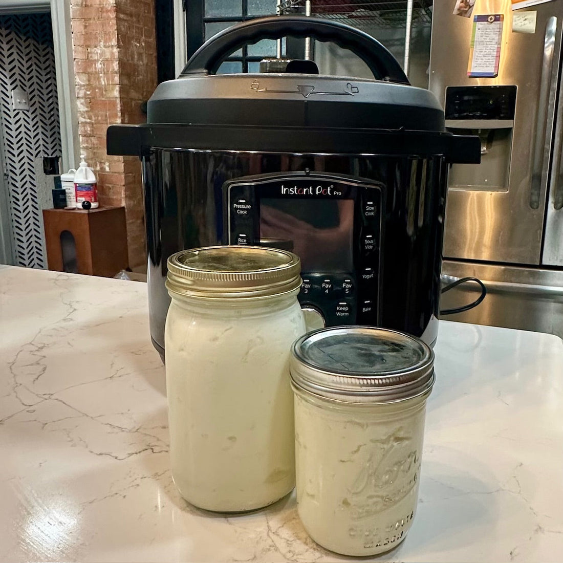 homemade yogurt in a jar in front of an instant pot